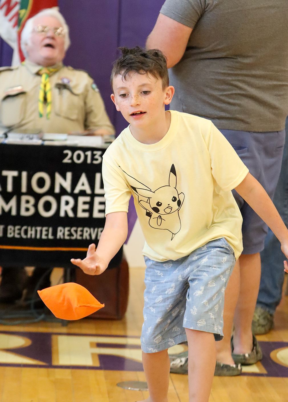  A student tosses a bean bag while playing cornhole at Healthy Family Night