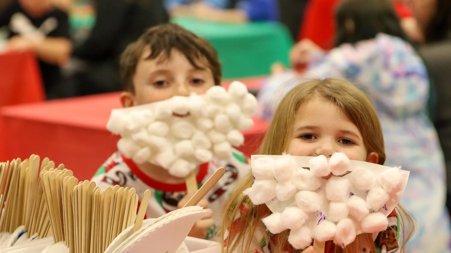  Fairley students show off the Santa beards they created during holiday craft night.  