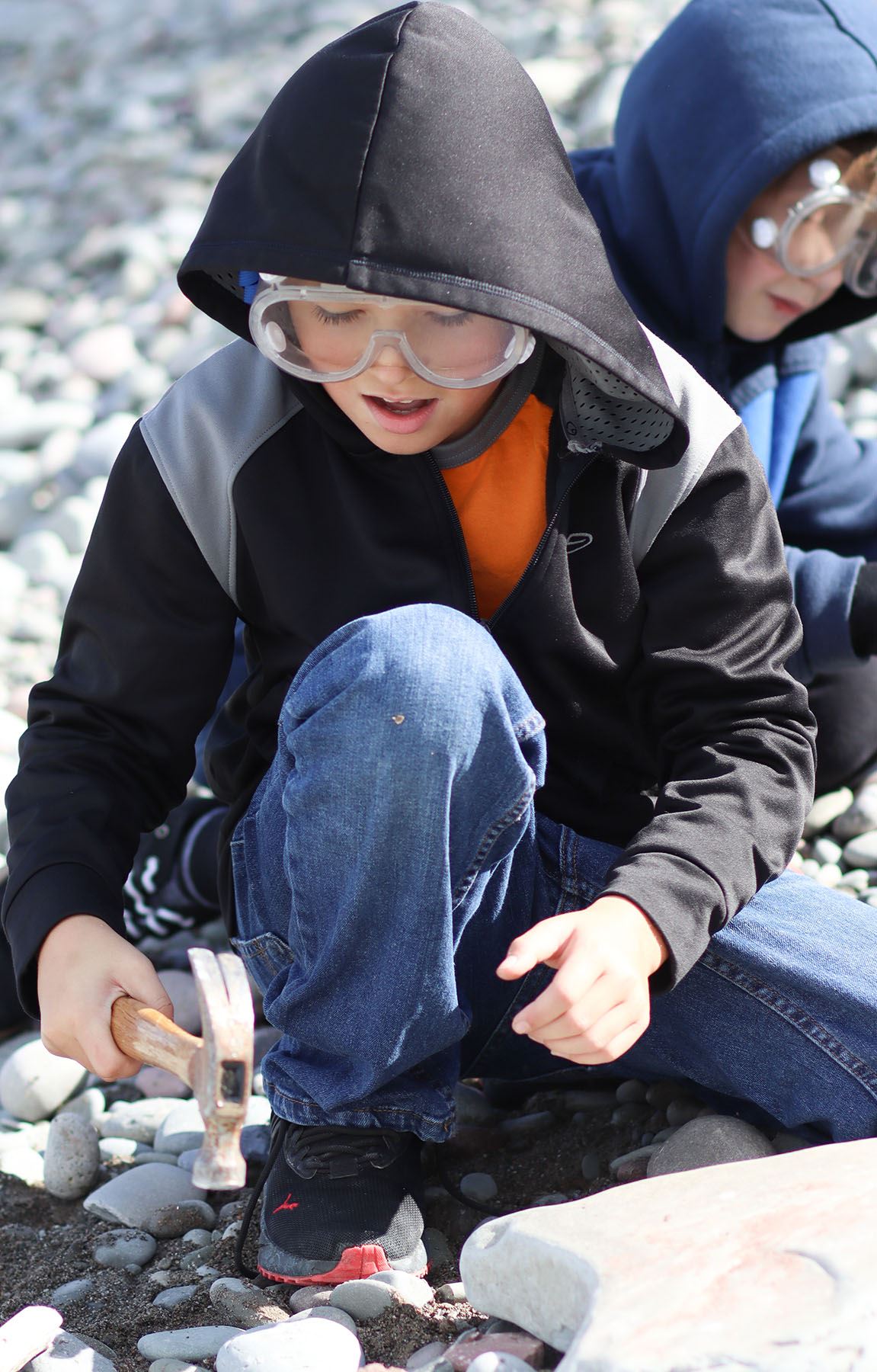  A Hannibal fourth-grader strikes a rock to examine its different layers during a field trip