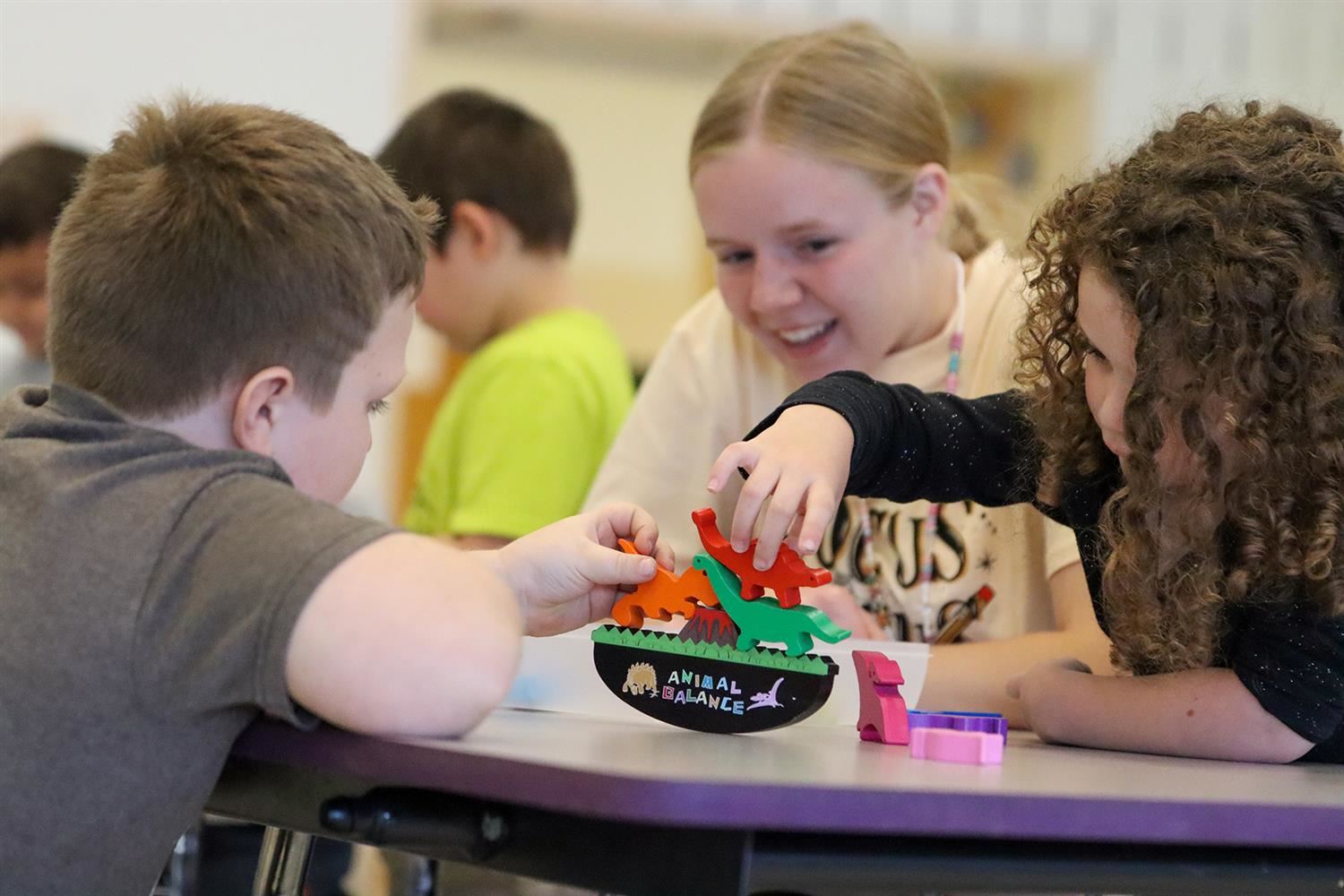  Teacher Chloe Weaver looks on as her students play together, using some of the items donated