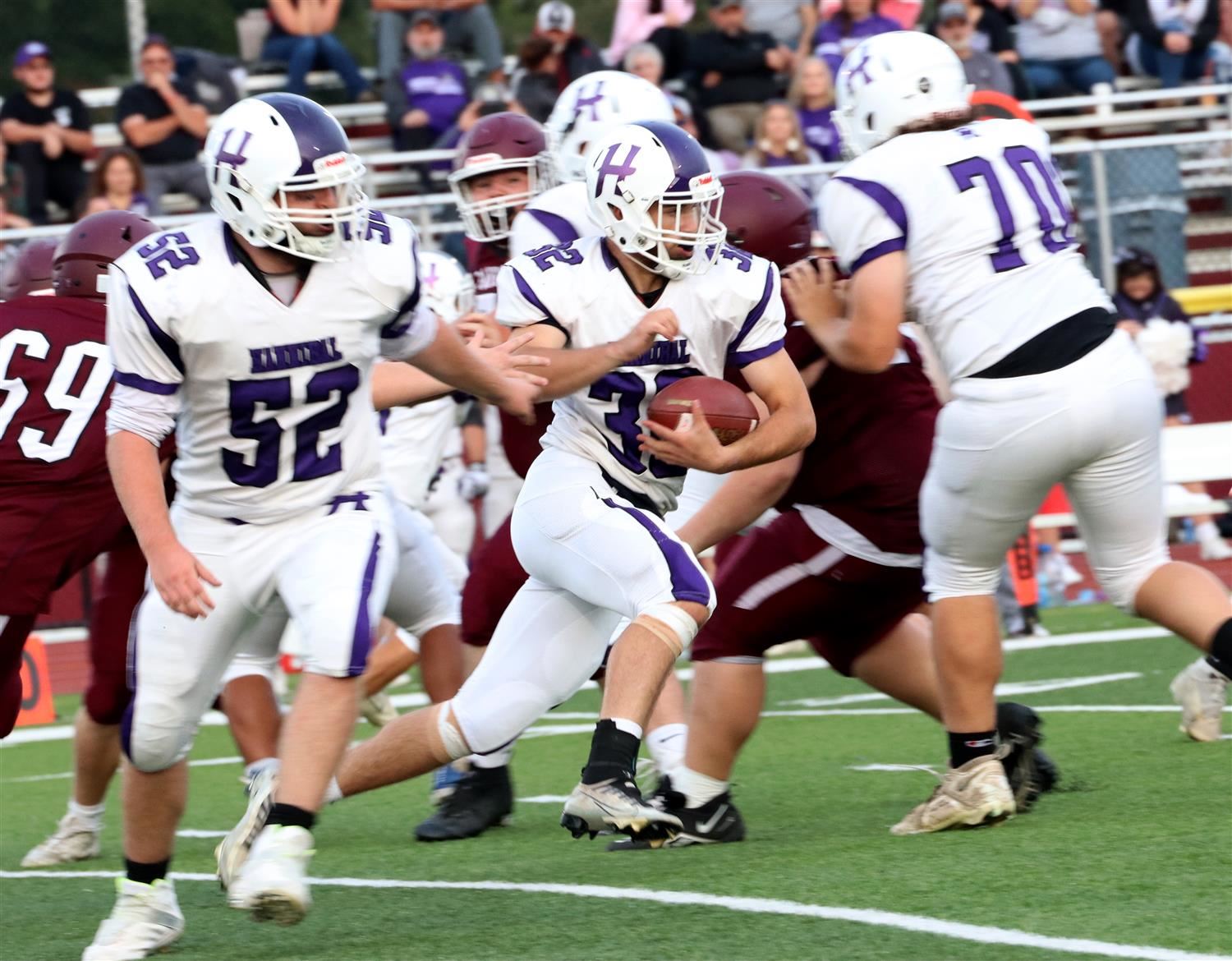 Hannibal football players run a play during the 23-24 season.