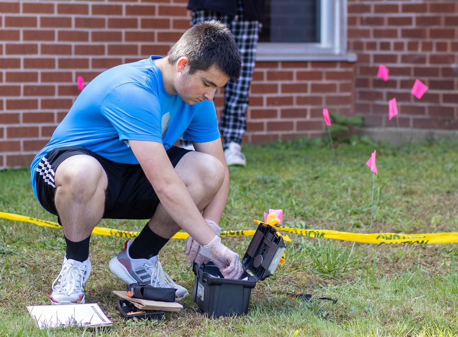  A SUPA forensics student processes a mock crime scene as part of a hands-on lesson.