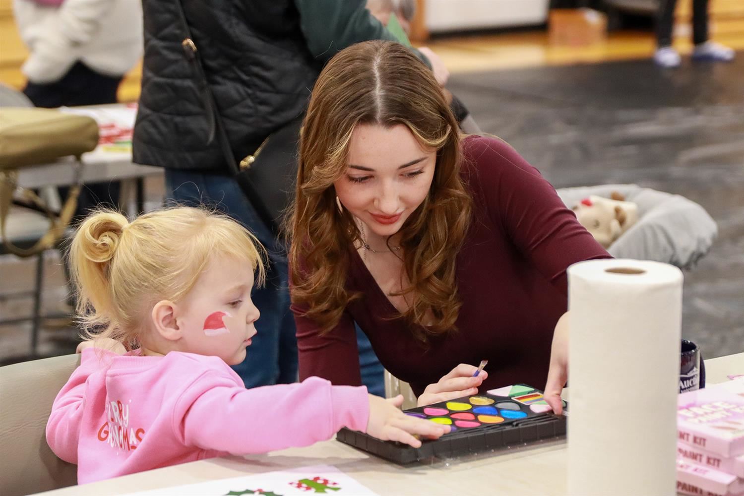  A child gets her face painted during this year’s Christmas Bureau carnival.